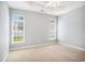 Bedroom with carpet floors, two windows bringing in natural light, and a tray ceiling with ceiling fan at 264 La Patos Dr., Myrtle Beach, SC 29588