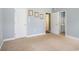 Bedroom view with light gray walls, carpet, access to bathroom and closet, and three framed art pieces at 264 La Patos Dr., Myrtle Beach, SC 29588