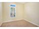 Bedroom showcasing a window with blinds, neutral paint, carpet flooring, and bright natural light at 264 La Patos Dr., Myrtle Beach, SC 29588