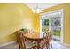 Bright dining area with wood table, chandelier, and sliding glass doors to the backyard at 264 La Patos Dr., Myrtle Beach, SC 29588