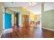 Inviting living room featuring hardwood floors, vaulted ceilings, and a bright blue front door at 264 La Patos Dr., Myrtle Beach, SC 29588