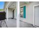 Charming covered porch with a white support columns and bright teal shutters at 264 La Patos Dr., Myrtle Beach, SC 29588