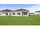 Home exterior with green lawn, covered patio, and neutral siding at 2700 Tranquility Loop, Longs, SC 29568