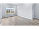 Bright bedroom features wood-look floors, two windows, and neutral walls at 2700 Tranquility Loop, Longs, SC 29568