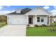 Charming single-Gathering home features a well-manicured lawn and a two-car garage at 2700 Tranquility Loop, Longs, SC 29568
