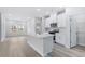 Bright kitchen with stainless steel appliances, island with seating, and open to the living room at 2700 Tranquility Loop, Longs, SC 29568