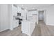 Modern kitchen features stainless steel appliances, island with seating, and white cabinetry at 2700 Tranquility Loop, Longs, SC 29568