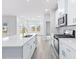 Kitchen has an island with seating, stainless steel appliances, and open to the living area at 2700 Tranquility Loop, Longs, SC 29568
