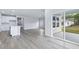 Open-concept living space with island, kitchen, and sliding glass door to backyard at 2700 Tranquility Loop, Longs, SC 29568