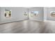 Beautiful living room with lots of natural light from multiple windows and wood look flooring at 2700 Tranquility Loop, Longs, SC 29568