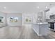 Bright living room features lots of natural light, open to the kitchen with wood look flooring at 2700 Tranquility Loop, Longs, SC 29568