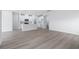 Bright living room with wood look flooring, open to a kitchen and a laundry room at 2700 Tranquility Loop, Longs, SC 29568