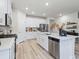 Modern kitchen with white cabinets, stainless steel appliances, and a large island at 2708 Tranquility Loop, Longs, SC 29568