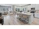 Open-concept kitchen with quartz countertops, white cabinets, stainless steel appliances, and views of living space at 2708 Tranquility Loop, Longs, SC 29568