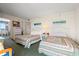 Warm bedroom with twin beds and a glimpse of the dining area at 2801 S Ocean Blvd. # 941, North Myrtle Beach, SC 29582