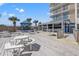 An inviting outdoor deck with picnic tables and chairs with views of the resort at 2801 S Ocean Blvd. # 941, North Myrtle Beach, SC 29582