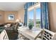 Dining area featuring a white table and chairs, and a view of the outdoors at 2801 S Ocean Blvd. # 941, North Myrtle Beach, SC 29582