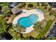 Overhead view of the outdoor pool with surrounding lounge area and lush landscaping at 310 73Rd Ave. N # 5B, Myrtle Beach, SC 29572