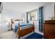 Cozy bedroom with a comfortable bed, soft lighting, and stylish curtains at 310 73Rd Ave. N # 5B, Myrtle Beach, SC 29572