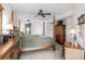 Bright bedroom featuring a four-poster bed, ceiling fan, and access to an ensuite bathroom at 310 73Rd Ave. N # 5B, Myrtle Beach, SC 29572