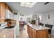 Open-concept kitchen leading to dining and living areas, features an island with barstool seating at 310 73Rd Ave. N # 5B, Myrtle Beach, SC 29572