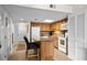 Well-lit kitchen with wood cabinetry, island with seating, and appliances, plus ample storage at 310 73Rd Ave. N # 5B, Myrtle Beach, SC 29572