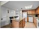 Functional kitchen featuring island seating, appliances, and easy access to other rooms at 310 73Rd Ave. N # 5B, Myrtle Beach, SC 29572
