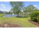A tranquil pond featuring a fountain, surrounded by lush green grass and mature trees at 314 Kiskadee Loop # 8-C, Conway, SC 29526