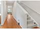 Hallway with hardwood floors leading to a carpeted staircase and living area at 314 Kiskadee Loop # 8-C, Conway, SC 29526