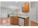 Well-lit kitchen featuring a stainless steel dishwasher and light oak cabinets at 314 Kiskadee Loop # 8-C, Conway, SC 29526