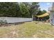 Large backyard with white fence, shed, and patio area, offering ample space for recreation at 3468 Trailside Dr., Little River, SC 29566