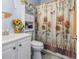 Bathroom with toilet and shower decorated with sunflowers at 3468 Trailside Dr., Little River, SC 29566