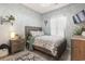 Bright bedroom with a wooden bedframe, light blue walls, a TV and nice decorations at 3468 Trailside Dr., Little River, SC 29566