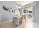 Bright dining area with sliding glass doors to the backyard and decorative mirrors at 3468 Trailside Dr., Little River, SC 29566