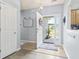 Bright foyer featuring wood flooring, a front door with sidelight, and views of the living spaces at 3468 Trailside Dr., Little River, SC 29566