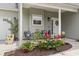 Inviting front porch with seating, a wreath on the door, and colorful flower arrangements at 3468 Trailside Dr., Little River, SC 29566