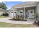 Inviting front porch with flowers, seating, and a charming wreath on the front door at 3468 Trailside Dr., Little River, SC 29566