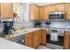 Well-equipped kitchen with stainless steel appliances and light wood cabinets at 3468 Trailside Dr., Little River, SC 29566
