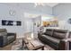 Comfortable living room featuring modern fireplace, recessed lighting, and a view to the foyer and kitchen at 3468 Trailside Dr., Little River, SC 29566