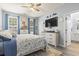 Comfortable main bedroom with two windows, blue curtains and view to the main bathroom at 3468 Trailside Dr., Little River, SC 29566