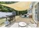 Inviting outdoor patio space with grill, fire pit, and comfortable seating under a sunshade at 3468 Trailside Dr., Little River, SC 29566