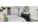 Serene main bedroom featuring a dresser, round mirror, and a comfortable bed with cozy linens and decorative pillows at 3599 Ashridge Way, Conway, SC 29526
