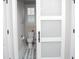 Contemporary half bathroom displaying a toilet, a shuttered window, and a stylish sliding door at 383 Mikita Dr., Surfside Beach, SC 29575