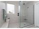 Bright bathroom showcasing a tiled walk-in shower with glass enclosure and a built-in bench at 383 Mikita Dr., Surfside Beach, SC 29575