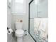 Neat and tidy bathroom featuring a toilet, shuttered window, and a glass shower with towels hanging at 383 Mikita Dr., Surfside Beach, SC 29575