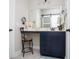 Elegant bathroom vanity featuring dark blue cabinets, a large mirror, and a comfortable vanity chair at 383 Mikita Dr., Surfside Beach, SC 29575