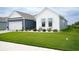Charming single-story home with a well-manicured lawn and cozy front porch seating at 383 Mikita Dr., Surfside Beach, SC 29575