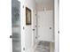 Hallway with a pantry door, neutral walls, light flooring, and framed art at 383 Mikita Dr., Surfside Beach, SC 29575