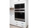 Modern kitchen appliances including microwave and oven with white cabinets and sleek handles at 383 Mikita Dr., Surfside Beach, SC 29575