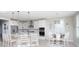 Bright kitchen with white cabinets, stainless steel appliances, island seating, and dining area at 383 Mikita Dr., Surfside Beach, SC 29575